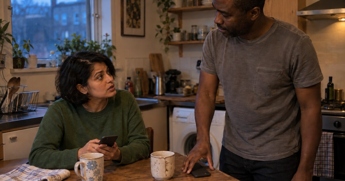 In a small flat’s kitchen in the early evening, a South Asian woman in her late thirties with short dark hair and a plain green jumper…
